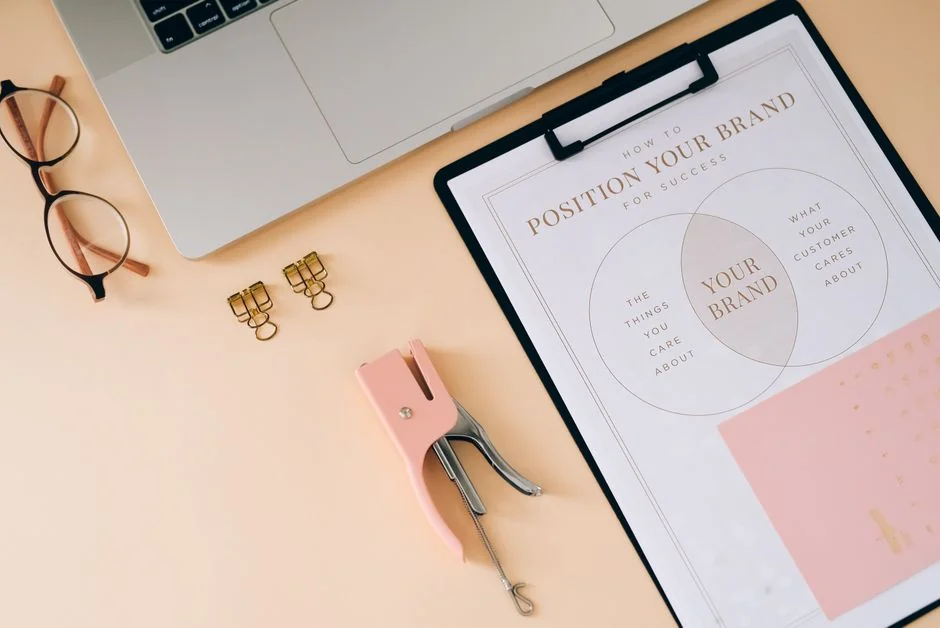 Hands typing on a laptop, with cryptocurrency charts and a smartphone screen visible, centered on digital finance.